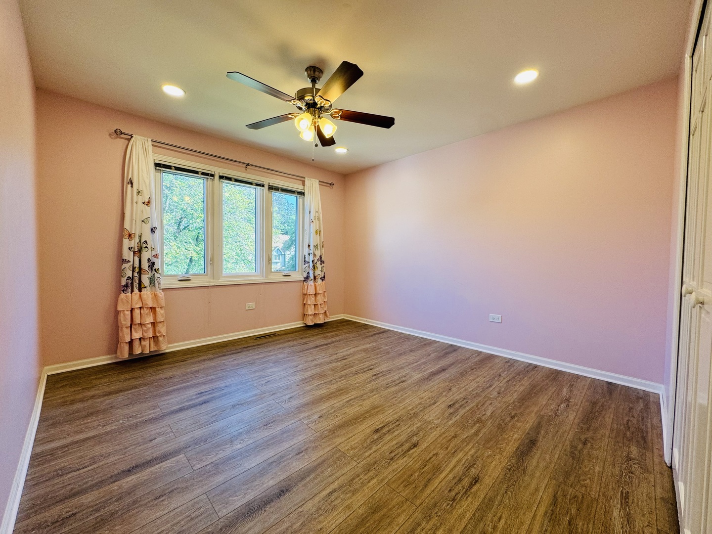 1398 East Gartner Road Naperville, IL 60540 - Photo 18 of 31 a view of an empty room with wooden floor and a window