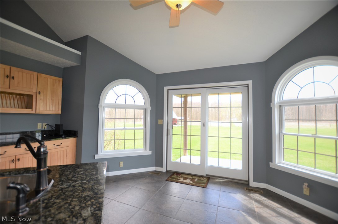 17871 Rowell Road Wellington, OH 44090 - Photo 10 of 34 View from family room into kitchen and eat-in kitchen area with tile floors