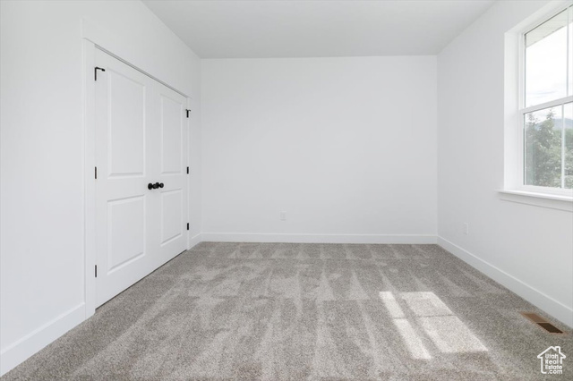 195 West 300 North Logan, UT 84321 - Photo 20 of 20 Unfurnished bedroom with carpet and a closet