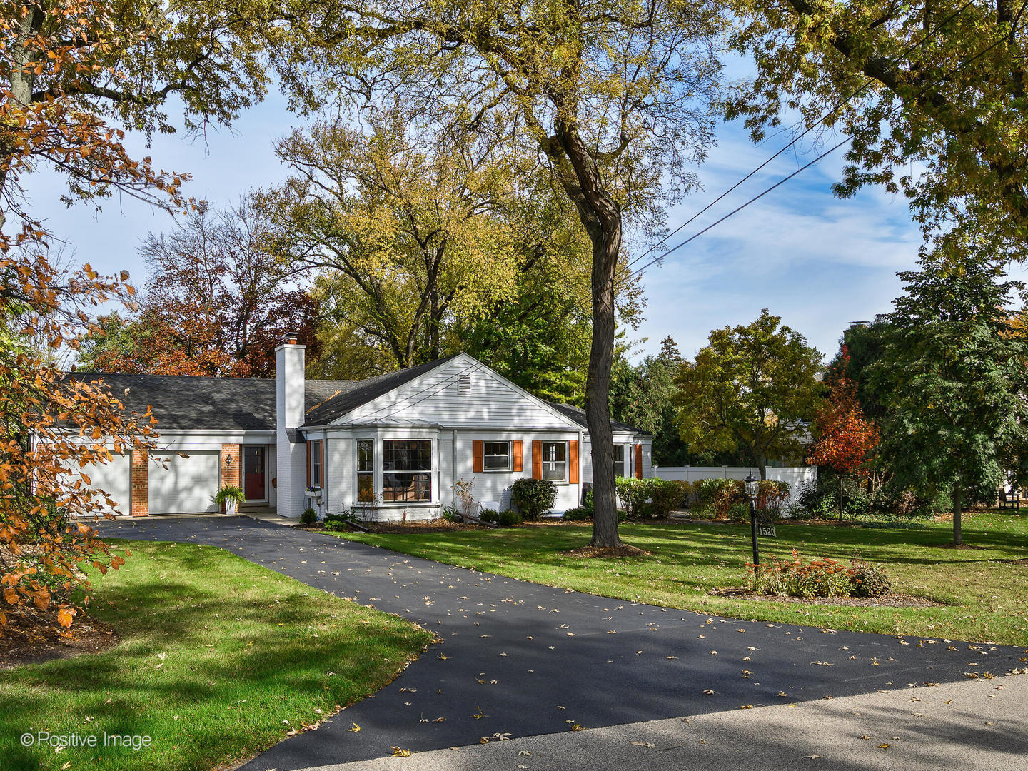 a front view of a house with a yard table and chairs