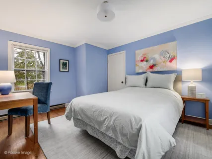 a bedroom with a bed and a desk