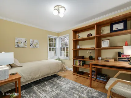 a bedroom with a bed and a bookshelf