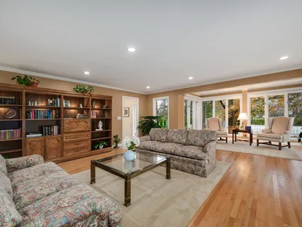 a living room with furniture and a book shelf