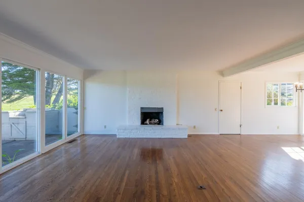 a living room with fireplace furniture and a large window