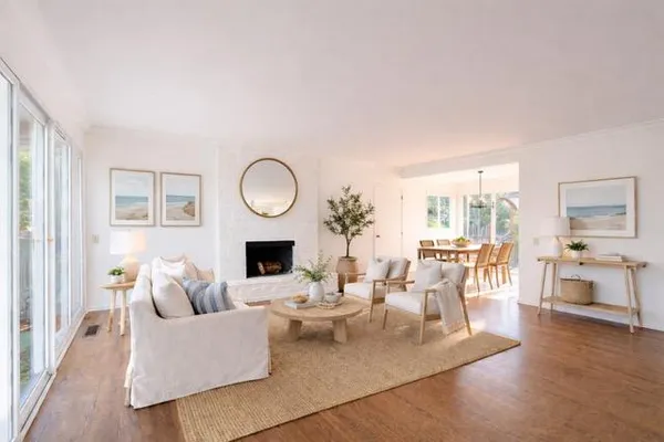 an empty room with wooden floor and fireplace