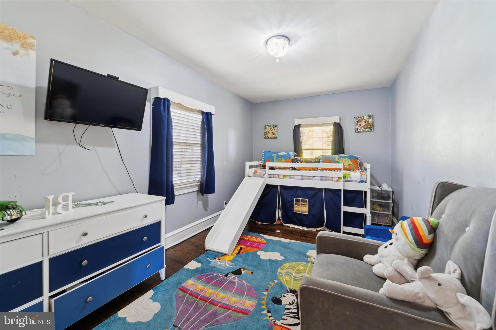 559 Broadview Road Upper Darby, PA 19082 - Photo 12 of 16 a bedroom with a bed and a flat screen tv