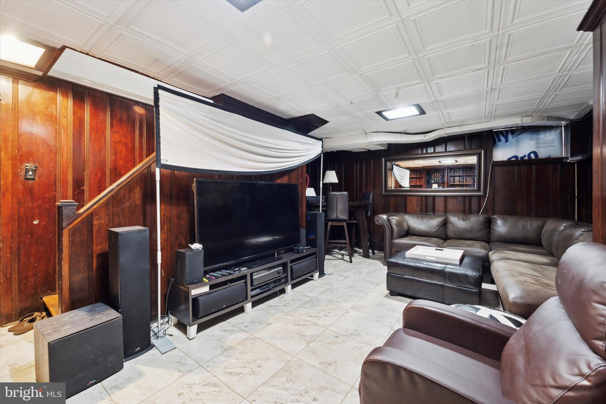 559 Broadview Road Upper Darby, PA 19082 - Photo 15 of 16 a living room with furniture and a flat screen tv