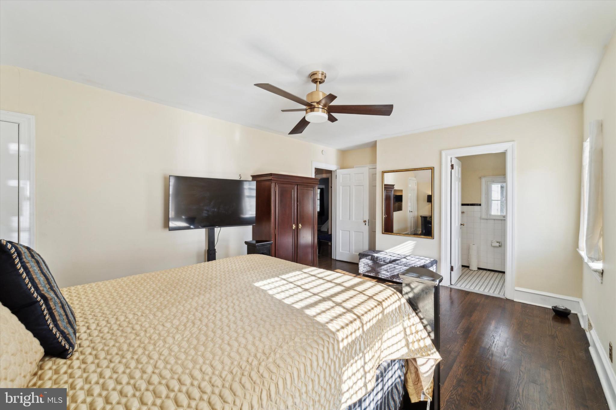 559 Broadview Road Upper Darby, PA 19082 - Photo 8 of 16 a bedroom with a bed and a flat screen tv