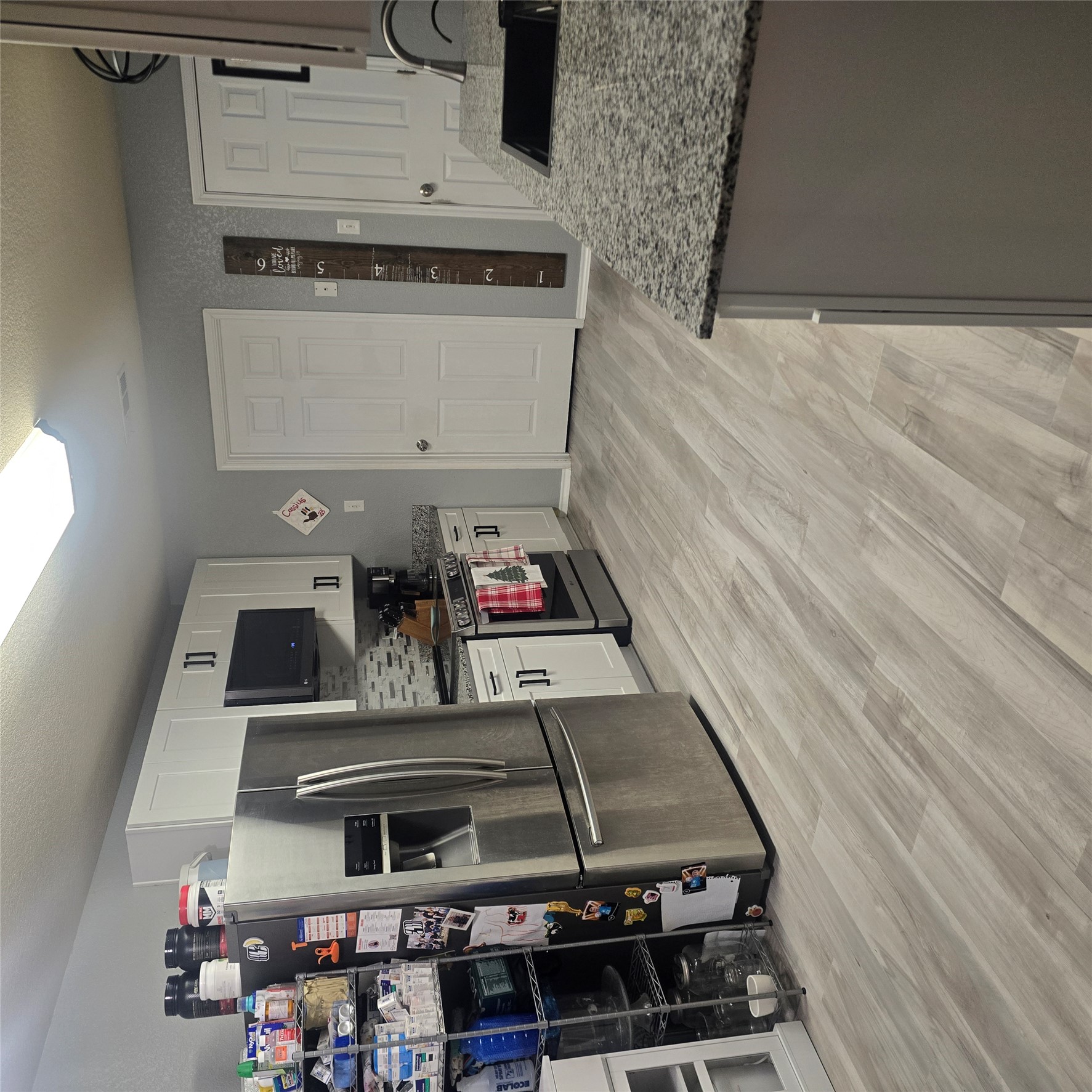 212 Druse Lane Jarrell, TX 76537 - Photo 11 of 39 a kitchen with granite countertop a refrigerator and a sink