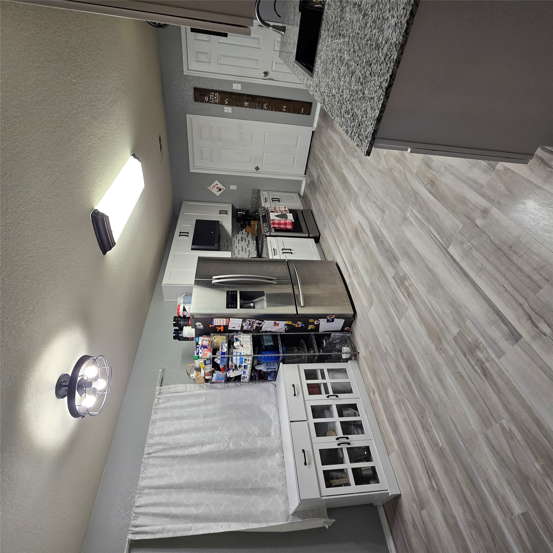212 Druse Lane Jarrell, TX 76537 - Photo 12 of 39 a open kitchen with stainless steel appliances granite countertop a refrigerator oven a stove and a wooden floors