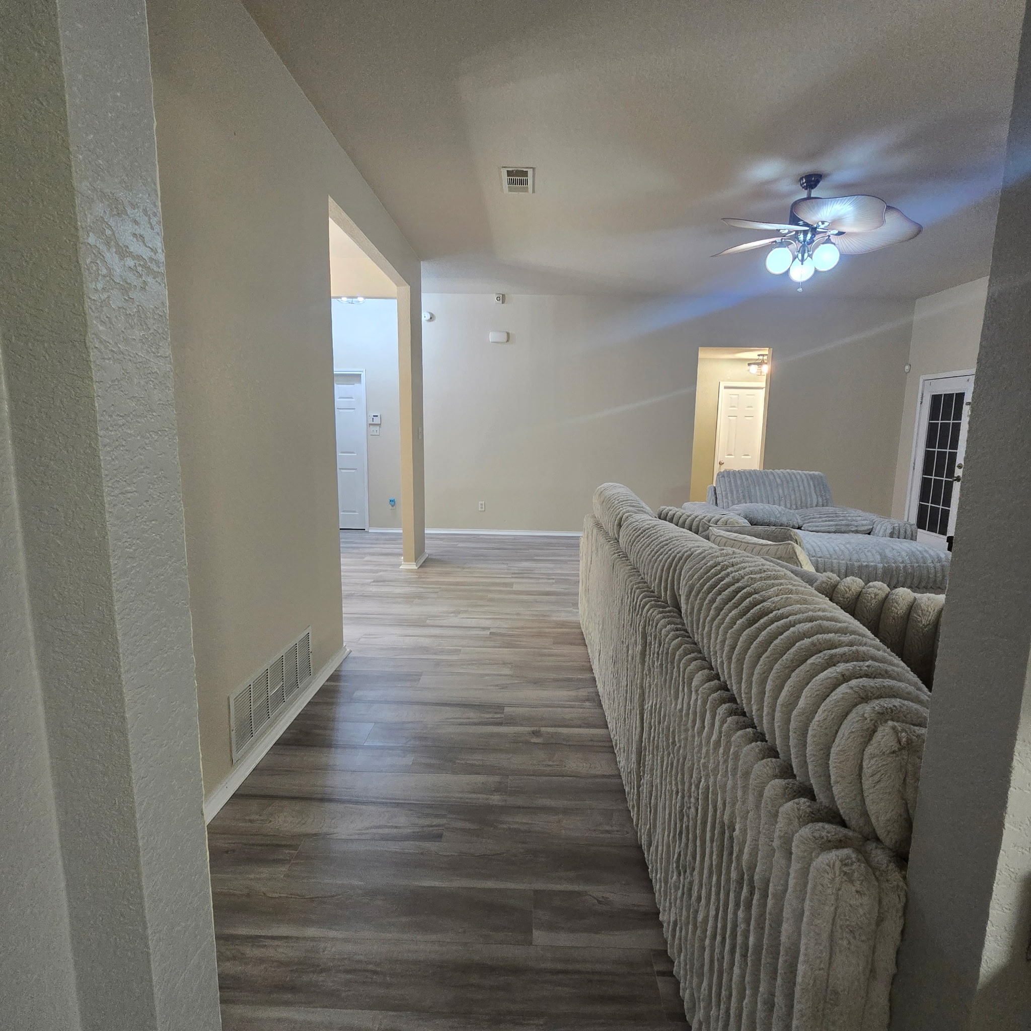 212 Druse Lane Jarrell, TX 76537 - Photo 16 of 39 a view of a livingroom with wooden floor and a ceiling fan
