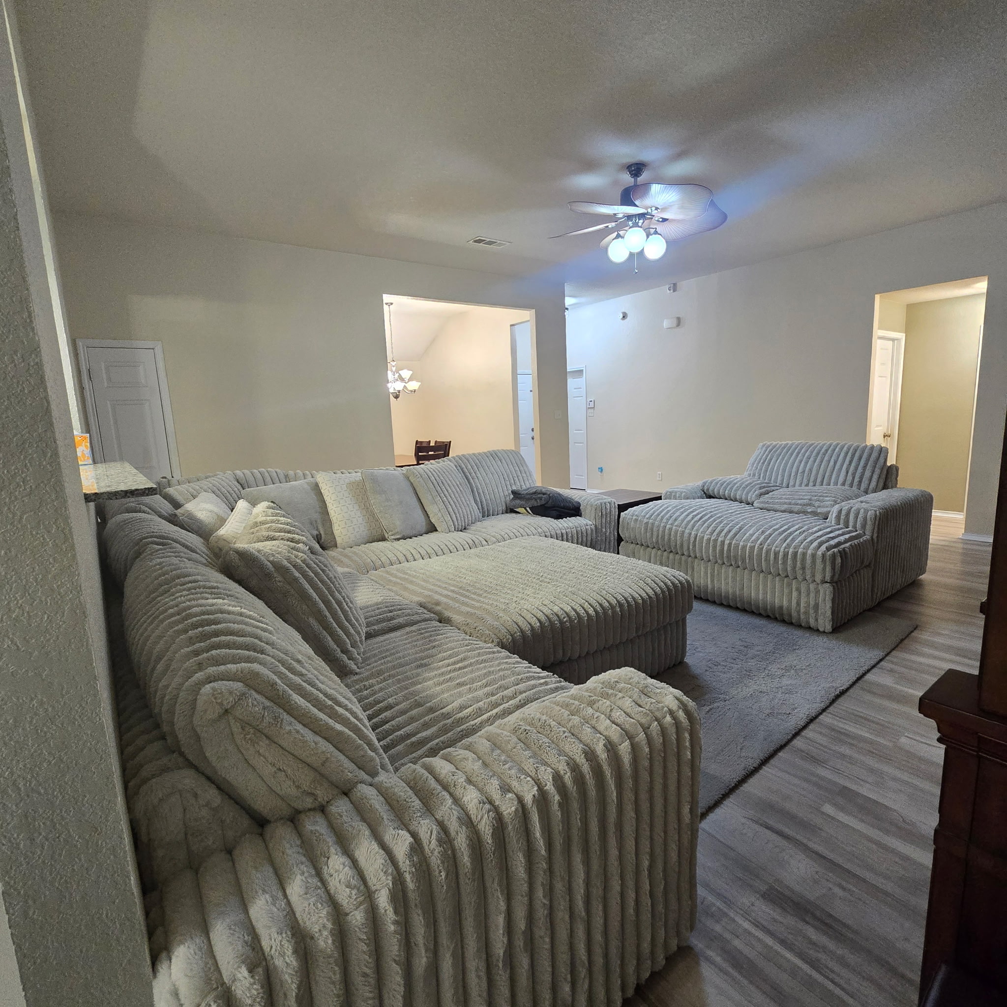 212 Druse Lane Jarrell, TX 76537 - Photo 17 of 39 a bedroom with a bed couch chandelier and a window