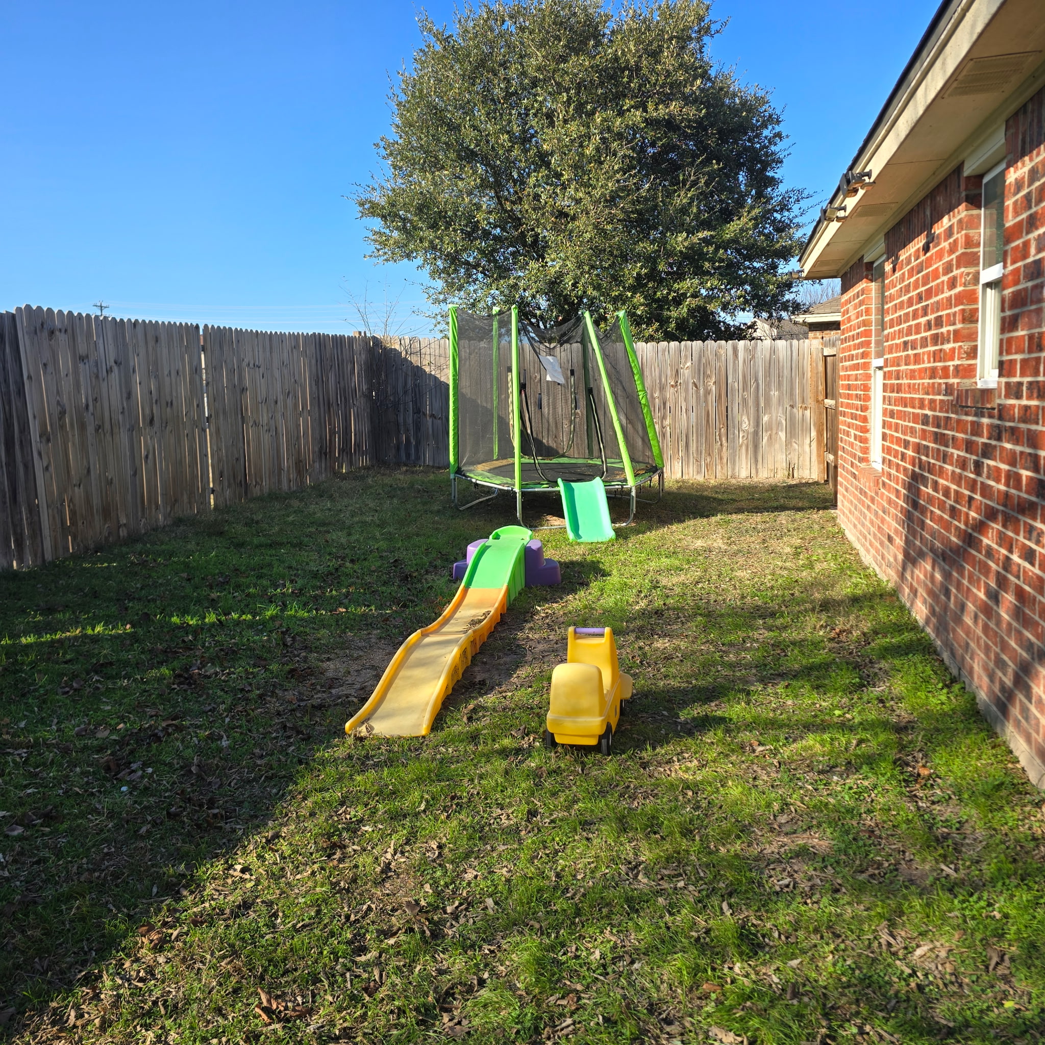 212 Druse Lane Jarrell, TX 76537 - Photo 37 of 39 a view of a backyard with table and chairs and wooden fence