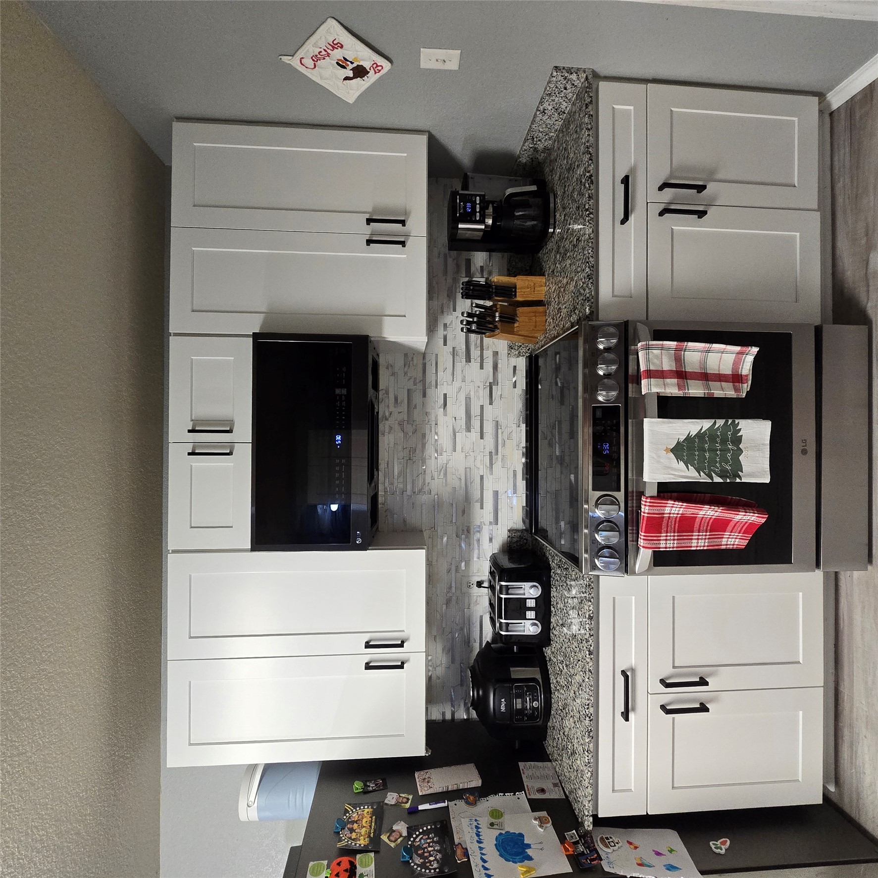 212 Druse Lane Jarrell, TX 76537 - Photo 10 of 39 a kitchen with stainless steel appliances granite countertop a stove a sink and a microwave