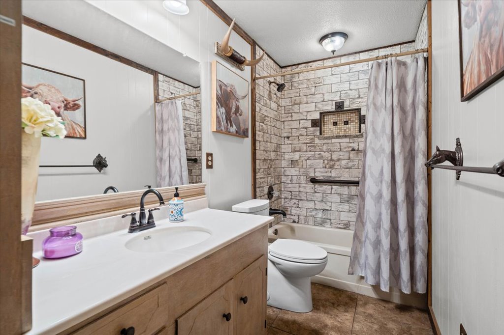 2421 Post Oak Road Webberville, TX 78653 - Photo 22 of 36 This bathroom has so much charm! Check out the accent tiling in the shower-tub combo designed to look like rustic whitewashed brick.