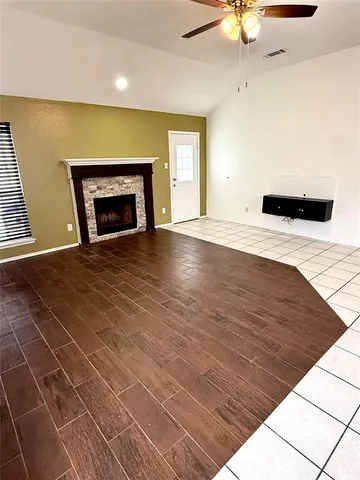 a view of an empty room with a fireplace
