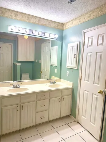 a bathroom with a double vanity sink mirror and