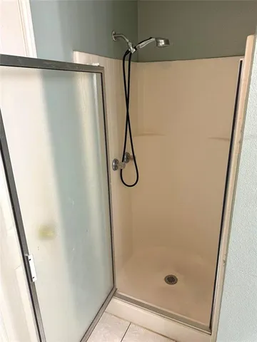 a bathroom with a glass shower door