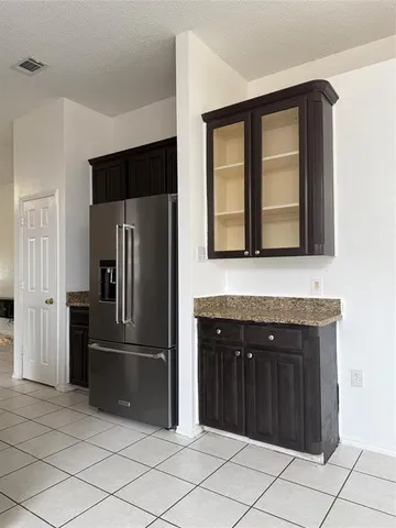 a kitchen with a refrigerator and a sink