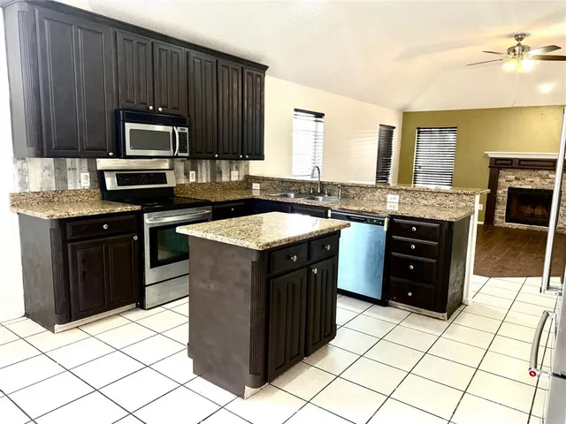 a kitchen with a stove a sink and a microwave