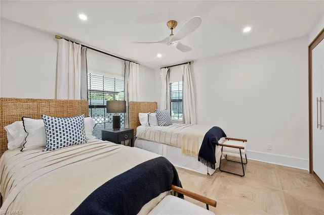 a bedroom with two beds and a chandelier