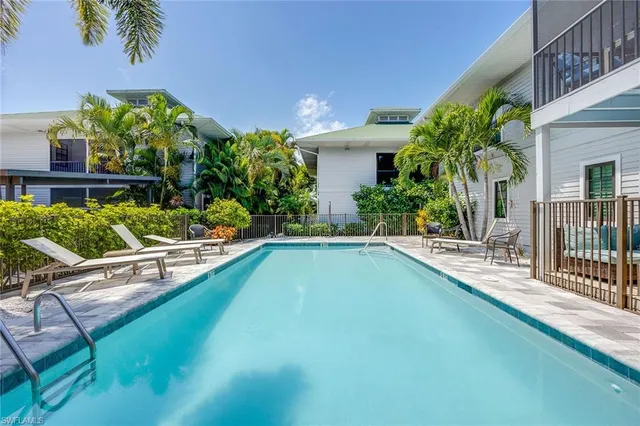 a view of a house with swimming pool and sitting area