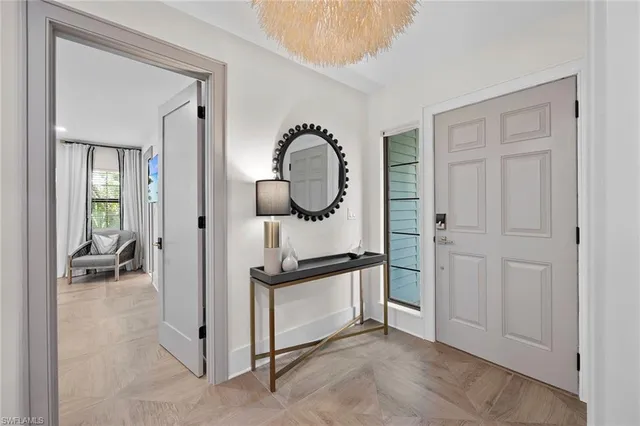 a view of a room that has a bed and a mirror in it