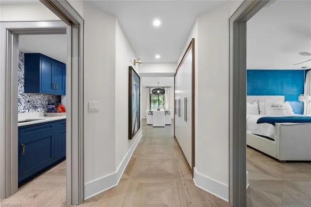 a view of a hallway and a livingroom with furniture