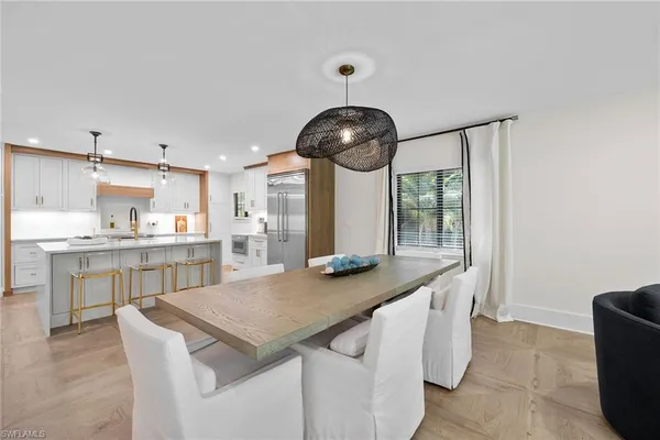 a kitchen with kitchen island stainless steel appliances a sink and cabinets