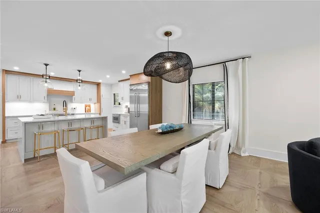 a kitchen with kitchen island stainless steel appliances a sink and cabinets