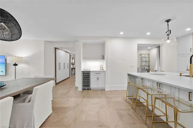 a spacious bathroom with a granite countertop sink a toilet a mirror and bathtub