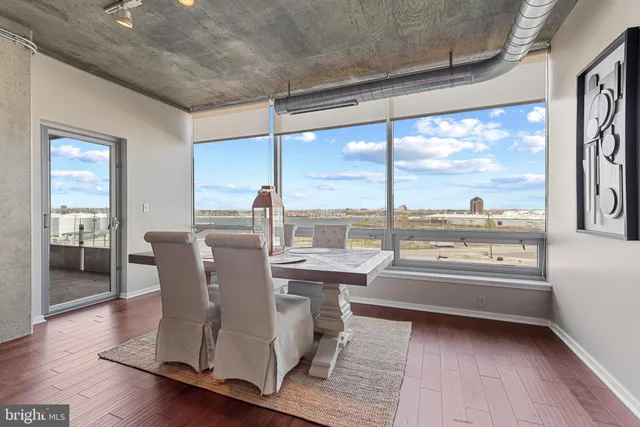 a dining room with table chairs and wooden floor
