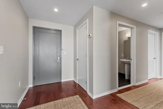 a view of a hallway with wooden floor