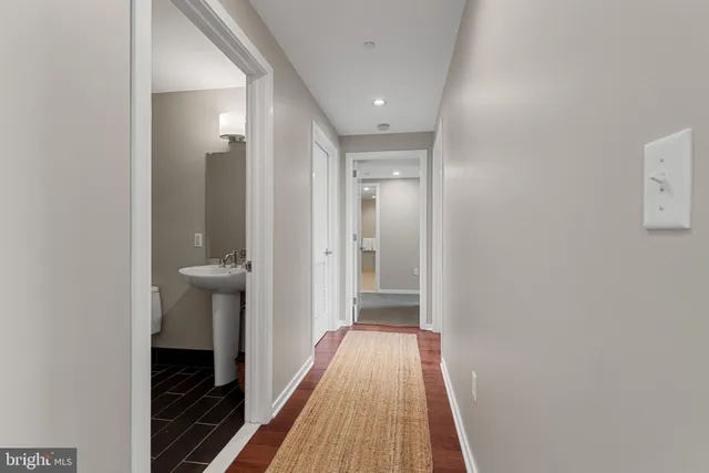 a view of hallway with wooden floor