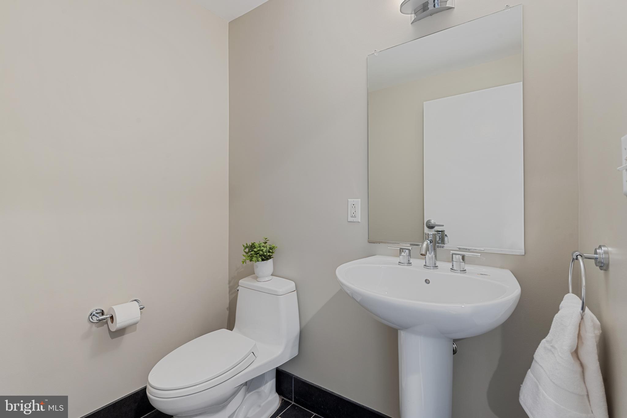 1200 Steuart Street, Unit 416 Baltimore, MD 21230 - Photo 21 of 37 a bathroom with a sink toilet and a mirror