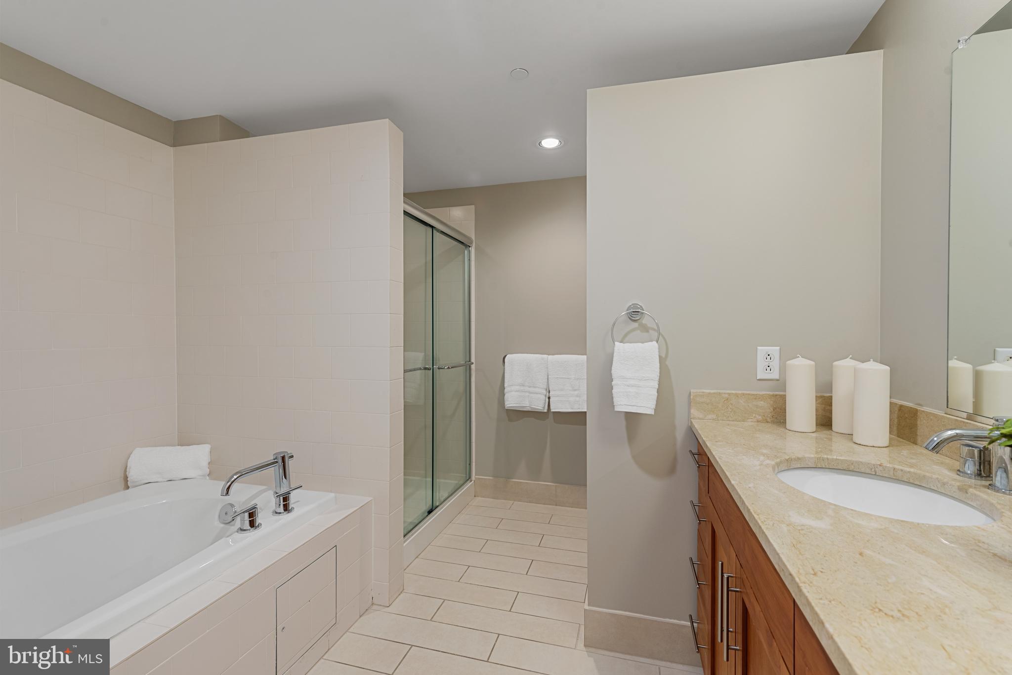 1200 Steuart Street, Unit 416 Baltimore, MD 21230 - Photo 24 of 37 a bathroom with a granite countertop sink and a mirror