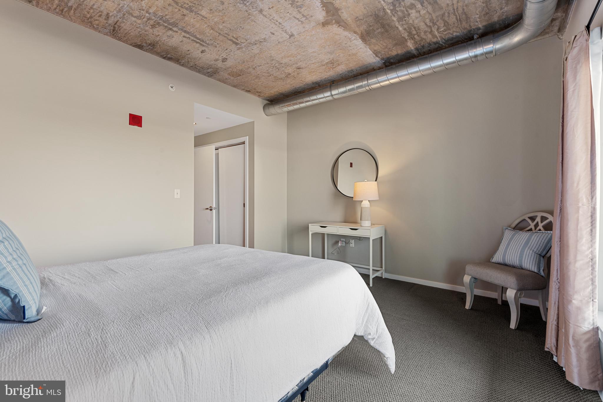 1200 Steuart Street, Unit 416 Baltimore, MD 21230 - Photo 29 of 37 a bedroom with a bed and a chair