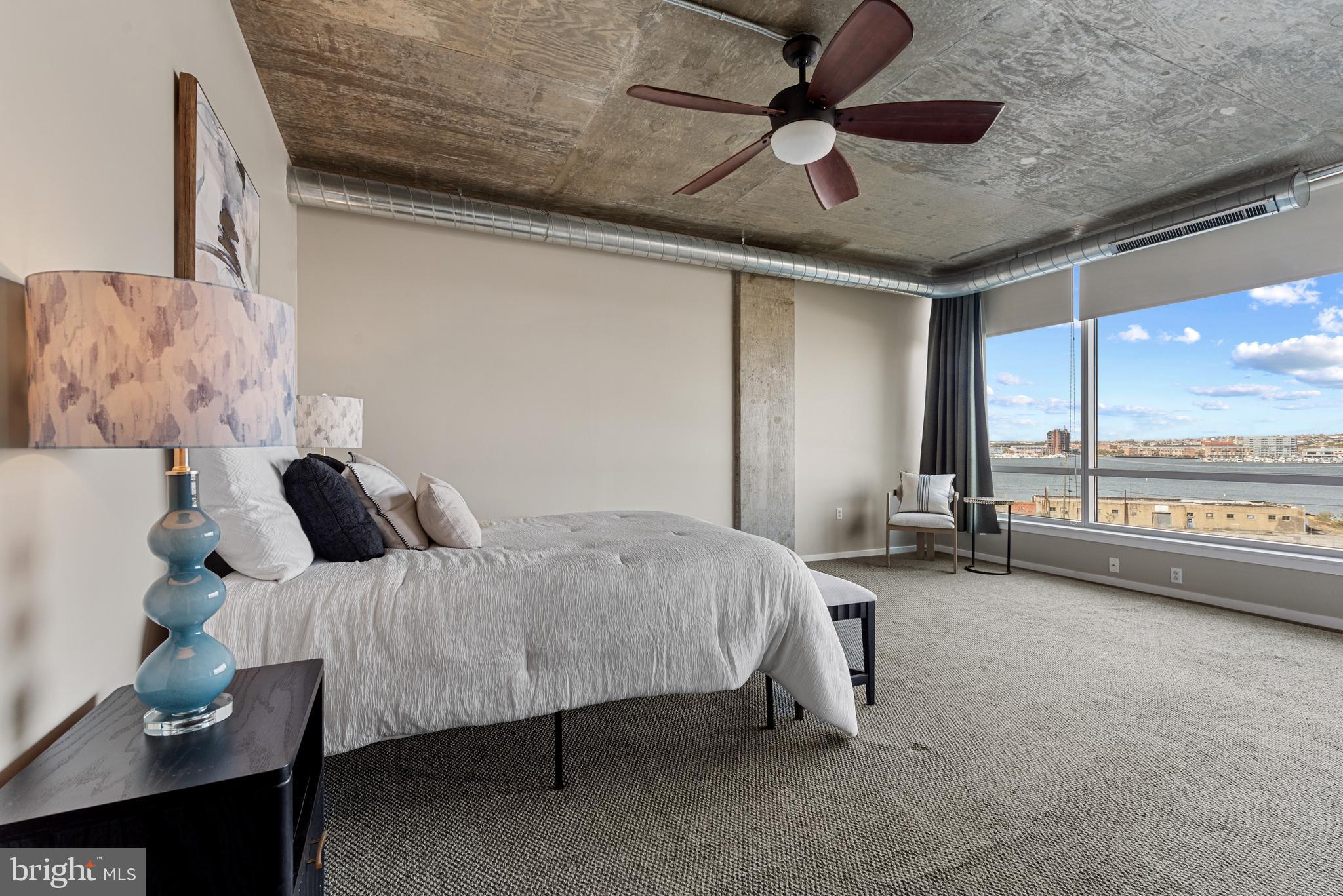 1200 Steuart Street, Unit 416 Baltimore, MD 21230 - Photo 30 of 37 a bedroom with a bed and a ceiling fan