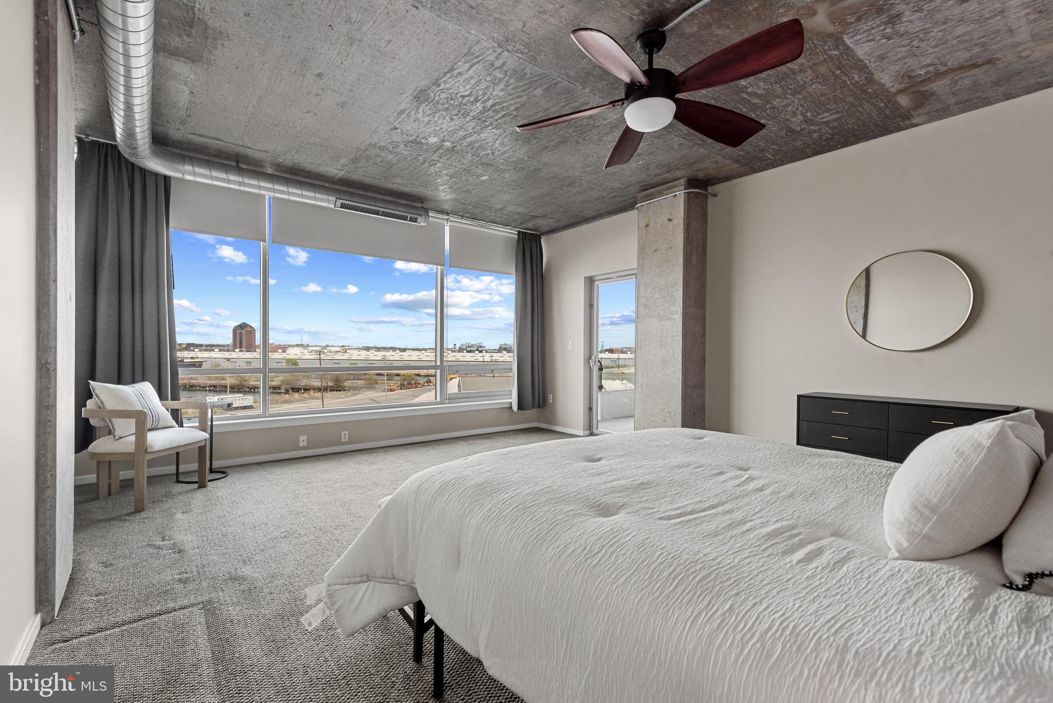 1200 Steuart Street, Unit 416 Baltimore, MD 21230 - Photo 34 of 37 a bedroom with a large bed and a large window