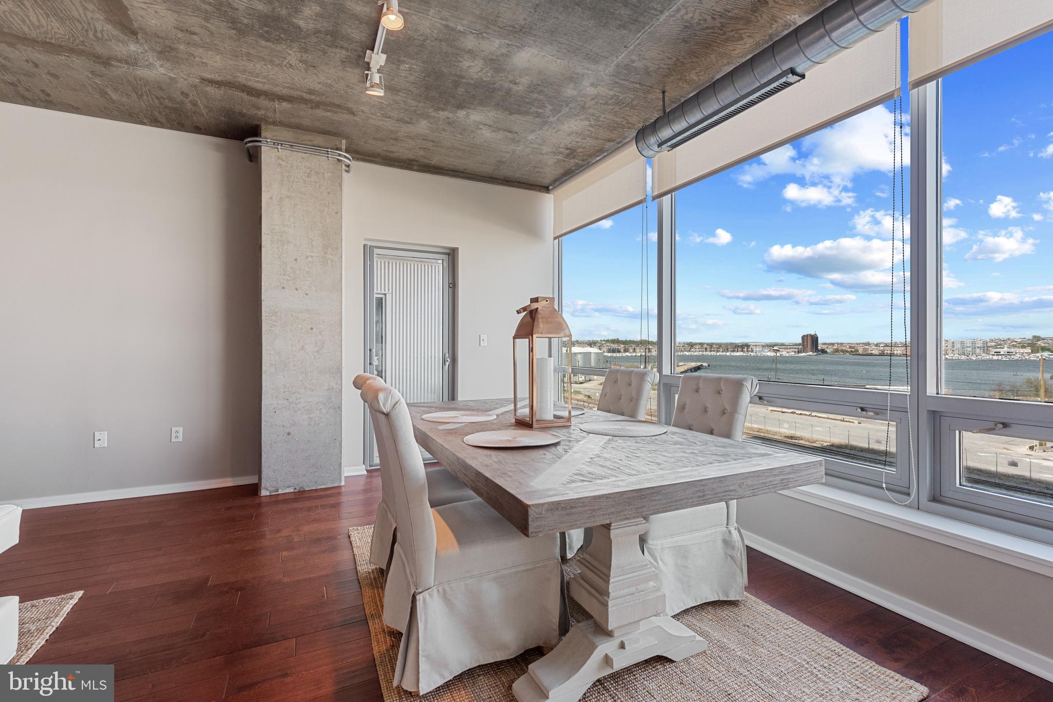 1200 Steuart Street, Unit 416 Baltimore, MD 21230 - Photo 4 of 37 a dining room with furniture and window