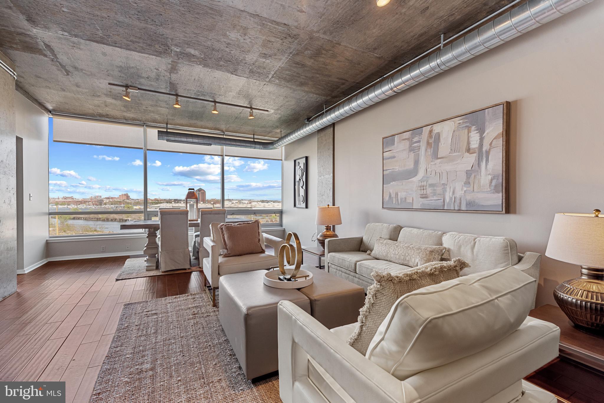 1200 Steuart Street, Unit 416 Baltimore, MD 21230 - Photo 7 of 37 a living room with furniture and a large window