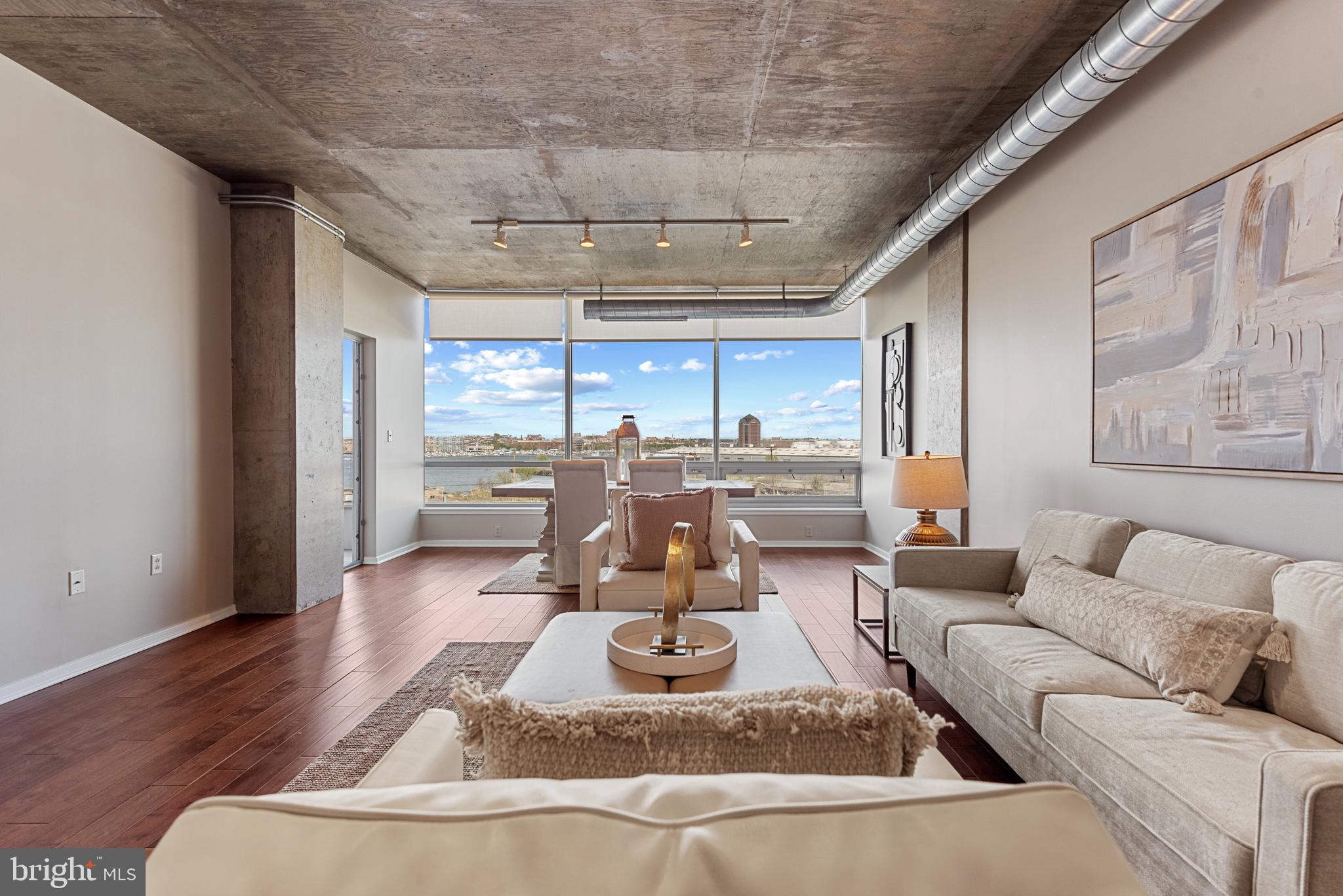 1200 Steuart Street, Unit 416 Baltimore, MD 21230 - Photo 8 of 37 a living room with furniture and a large window