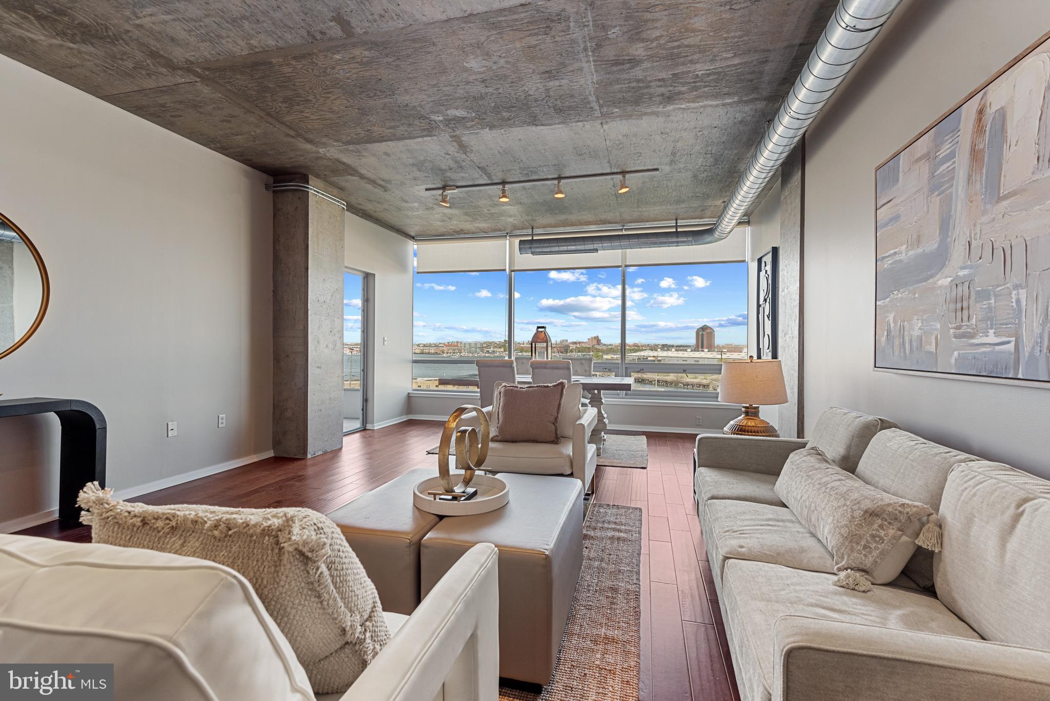 1200 Steuart Street, Unit 416 Baltimore, MD 21230 - Photo 9 of 37 a living room with furniture and a large window