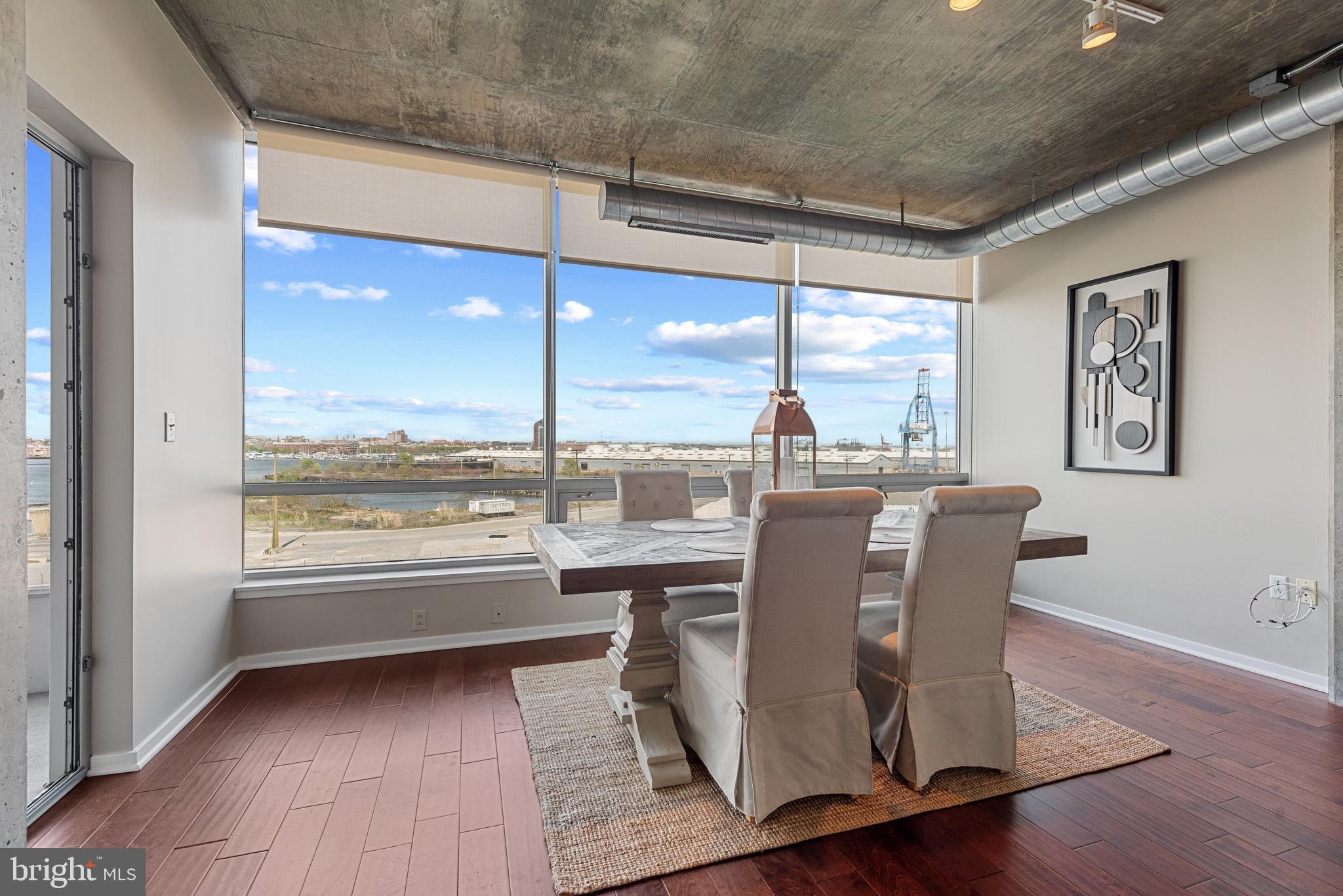 1200 Steuart Street, Unit 416 Baltimore, MD 21230 - Photo 10 of 37 a view of a dining room with furniture window and wooden floor