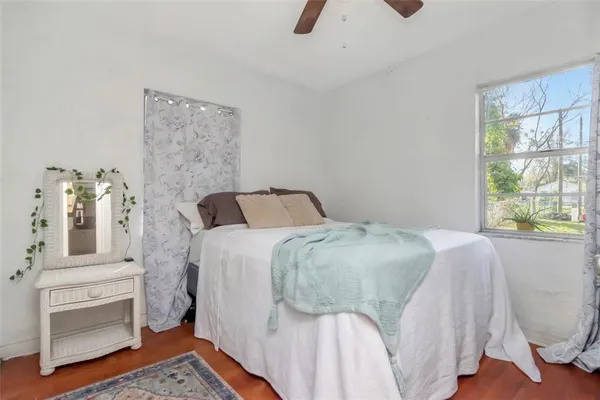 a bedroom with a bed couch and a window
