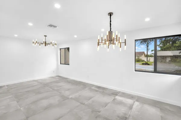 a view of entryway and hall with chandelier