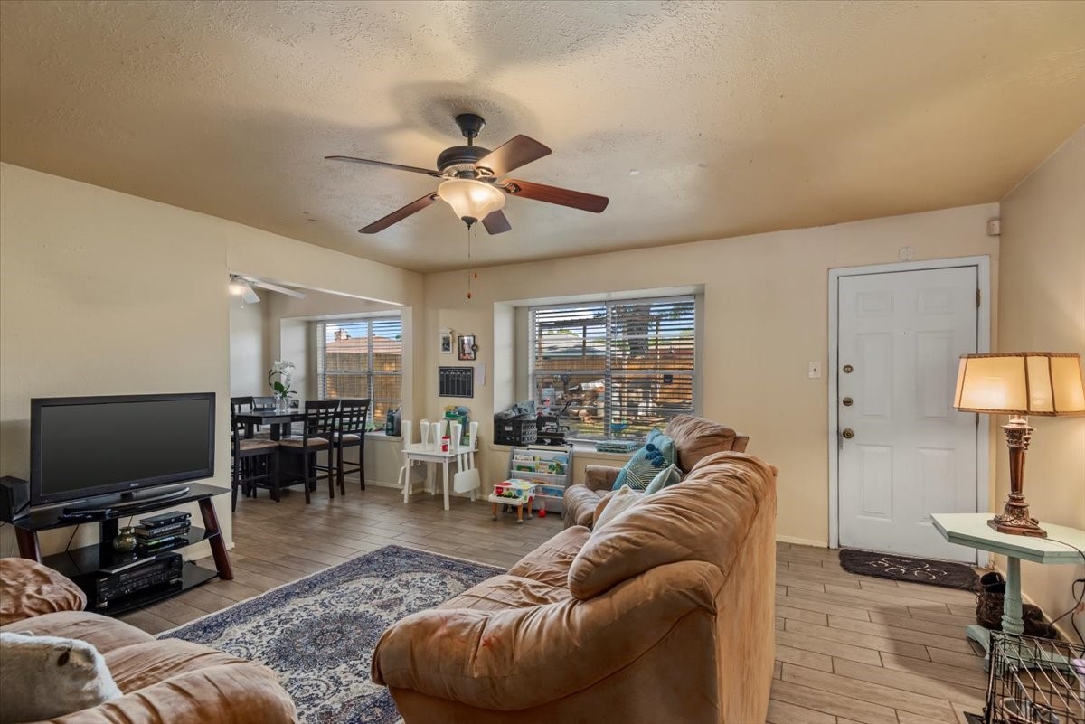 7510 Bubbling Spring Lane Houston, TX 77086 - Photo 7 of 18 a living room with furniture and a flat screen tv with wooden floor