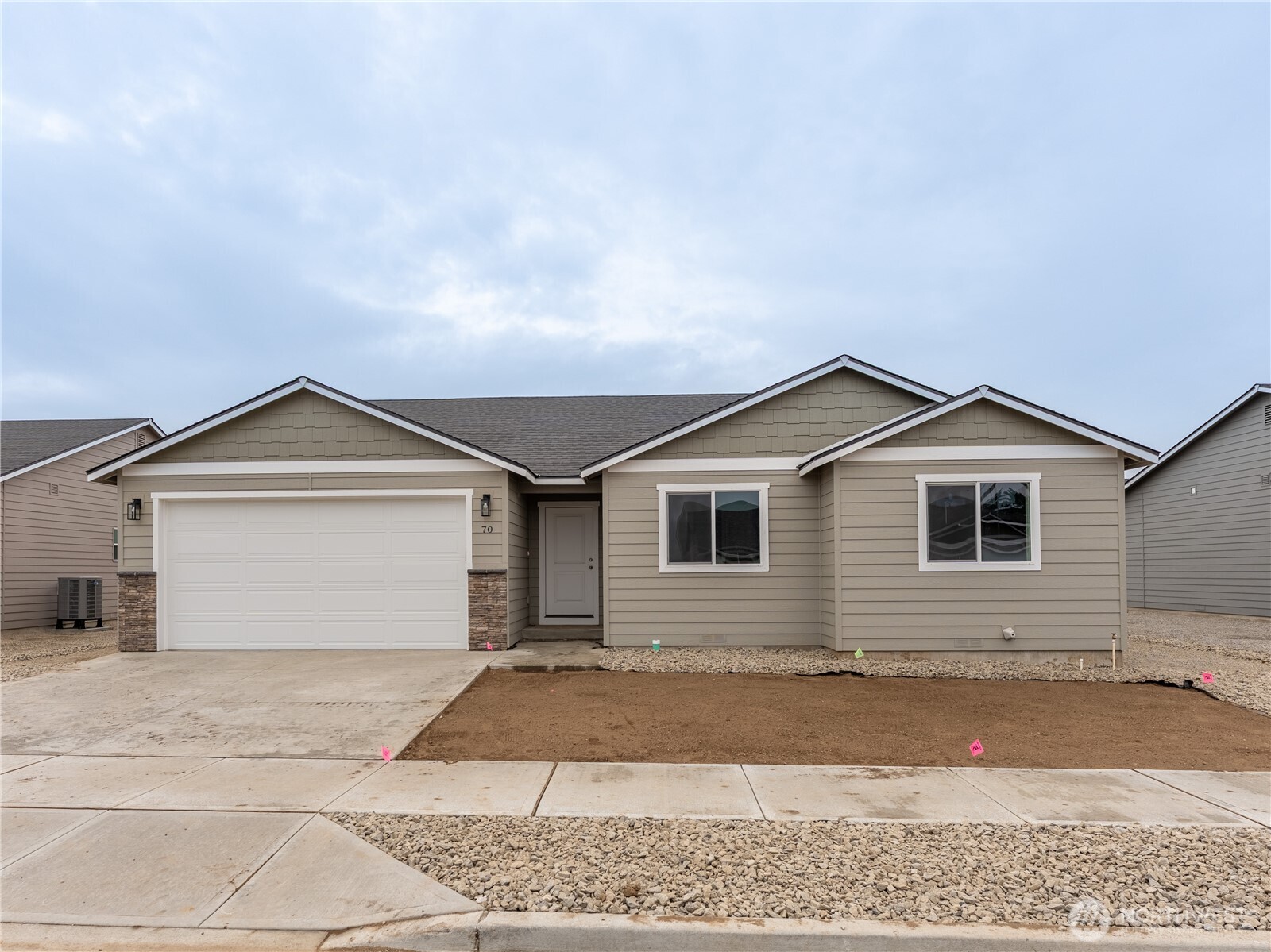 a view of a house with a yard and large tree