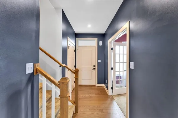 a view of an entryway with wooden floor and stairs