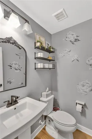 a bathroom with a sink mirror vanity and toilet